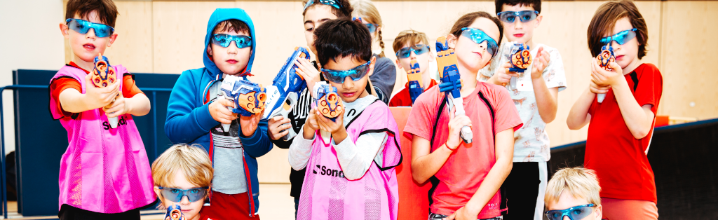 Kids having fun with soft battle games during a Premier Education Multi-activity Holiday Camp.